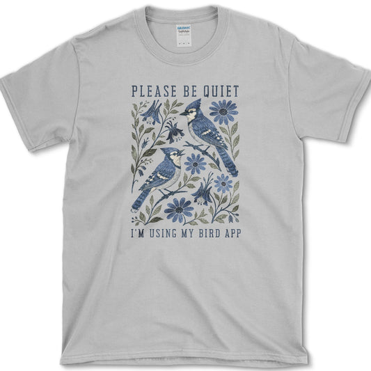Two blue jays perched among blue flowers with Please Be Quiet, I am Using My Bird App lettering