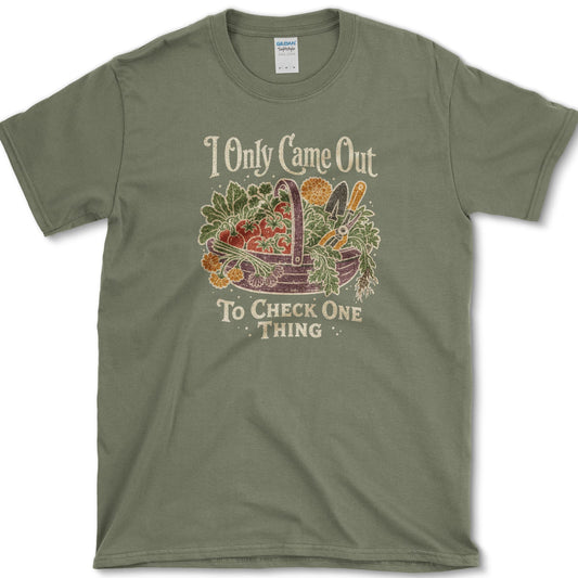 Overflowing basket of tomatoes, greens, carrots, and garden vegetables on a T-shirt