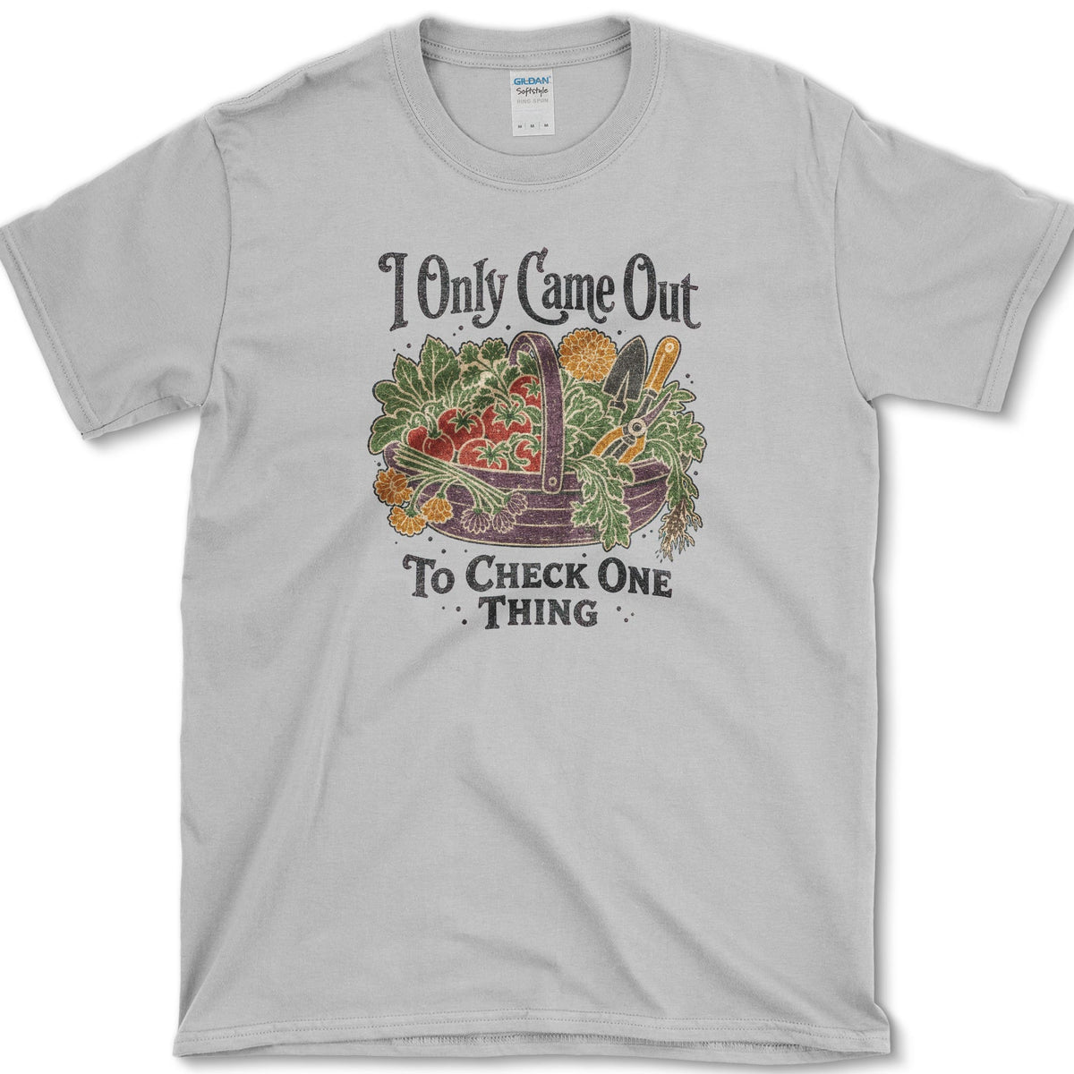 Overflowing basket of tomatoes, greens, carrots, and garden vegetables on a T-shirt