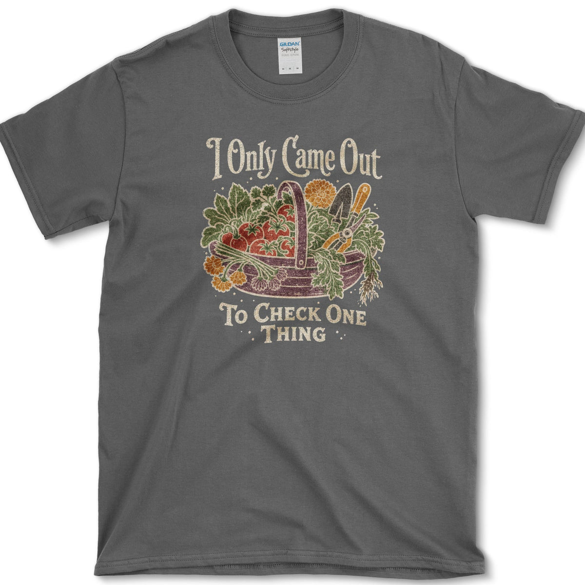 Overflowing basket of tomatoes, greens, carrots, and garden vegetables on a T-shirt