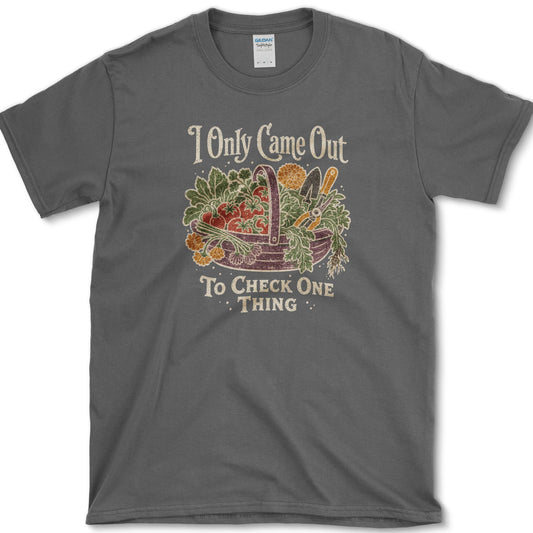 Overflowing basket of tomatoes, greens, carrots, and garden vegetables on a T-shirt