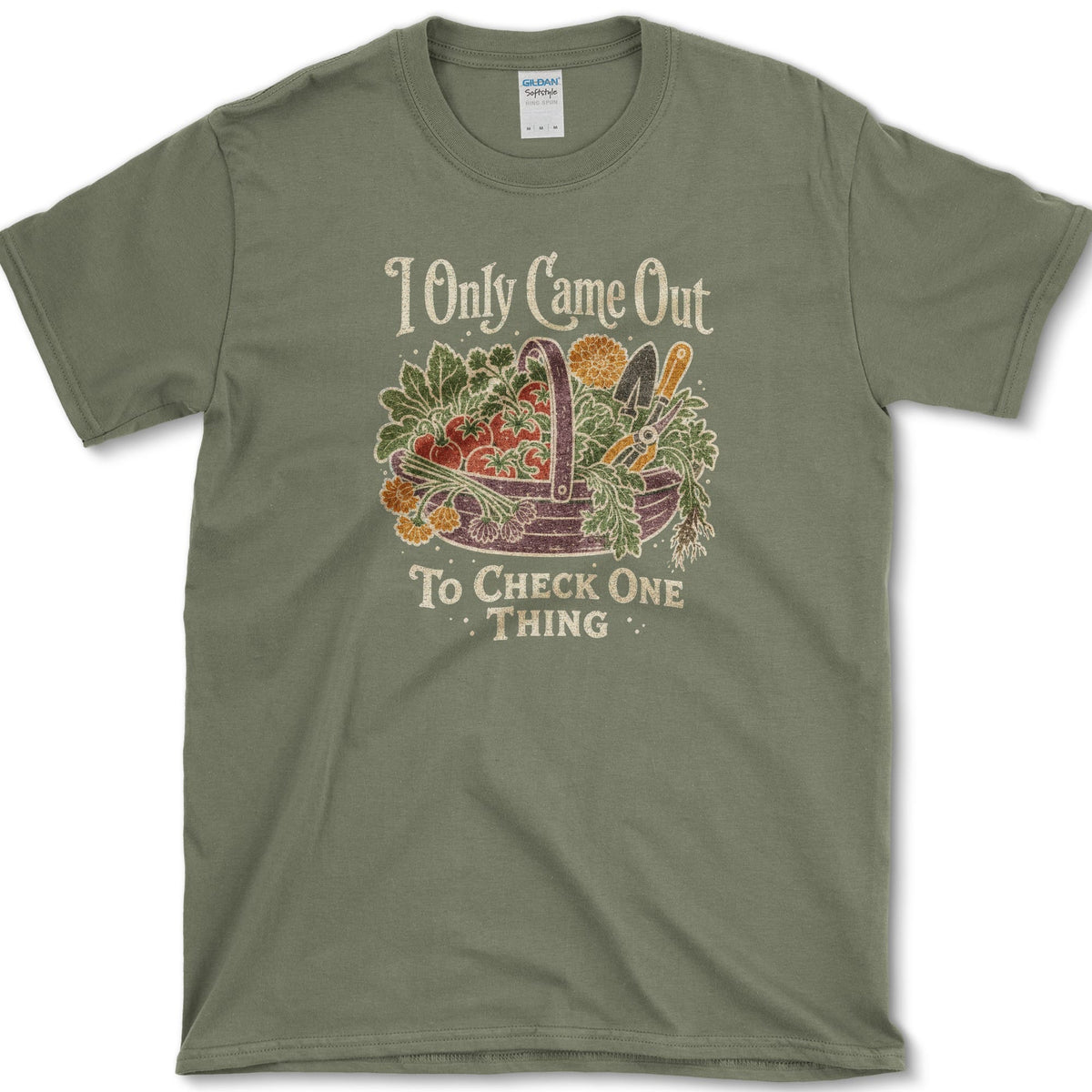 Overflowing basket of tomatoes, greens, carrots, and garden vegetables on a T-shirt