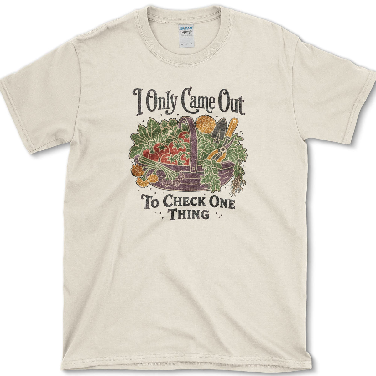 Overflowing basket of tomatoes, greens, carrots, and garden vegetables on a T-shirt