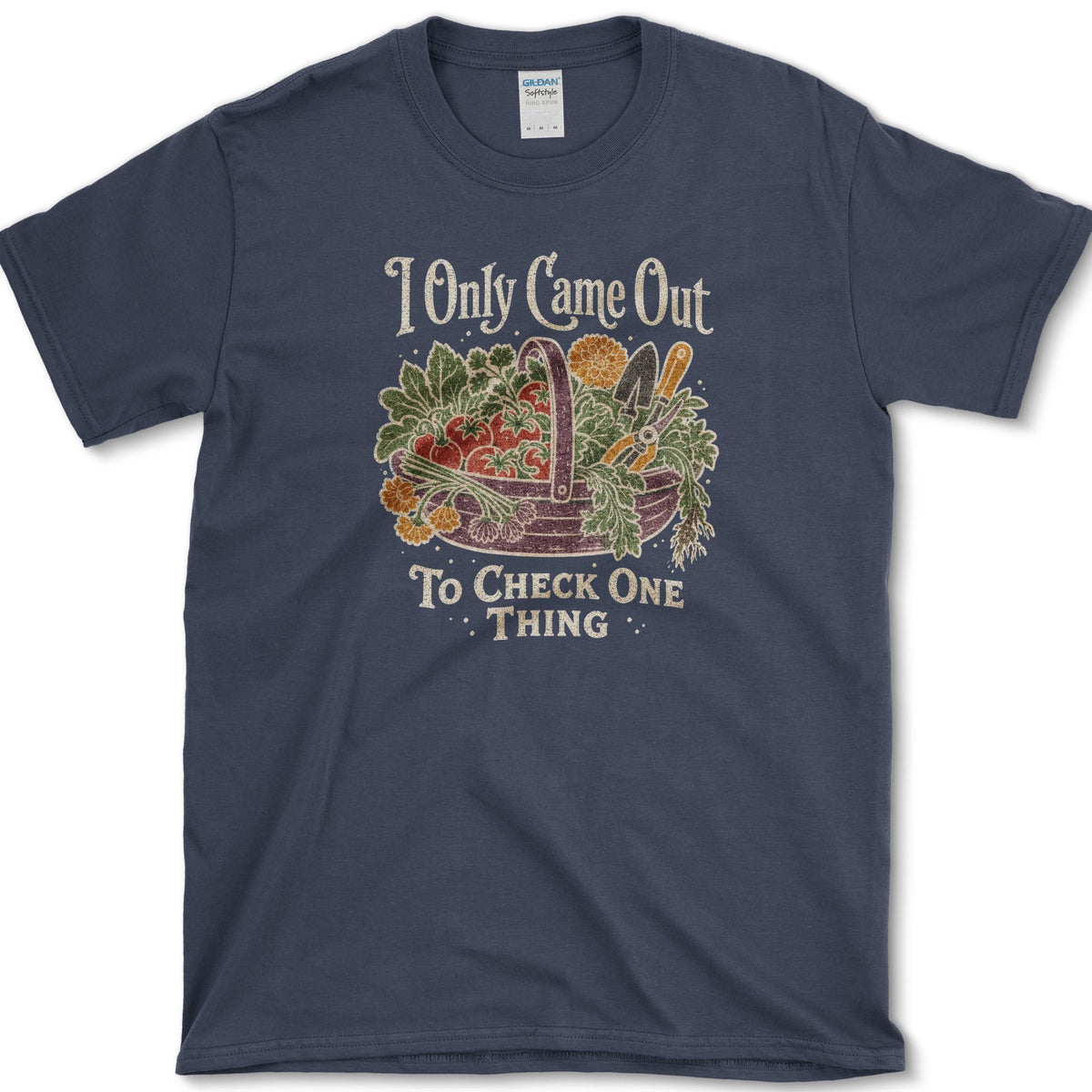 Overflowing basket of tomatoes, greens, carrots, and garden vegetables on a T-shirt