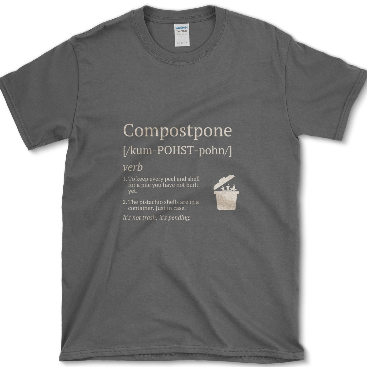 Cream Compostpone mock dictionary entry with a small kitchen-scrap bin and hand illustration on a T-shirt