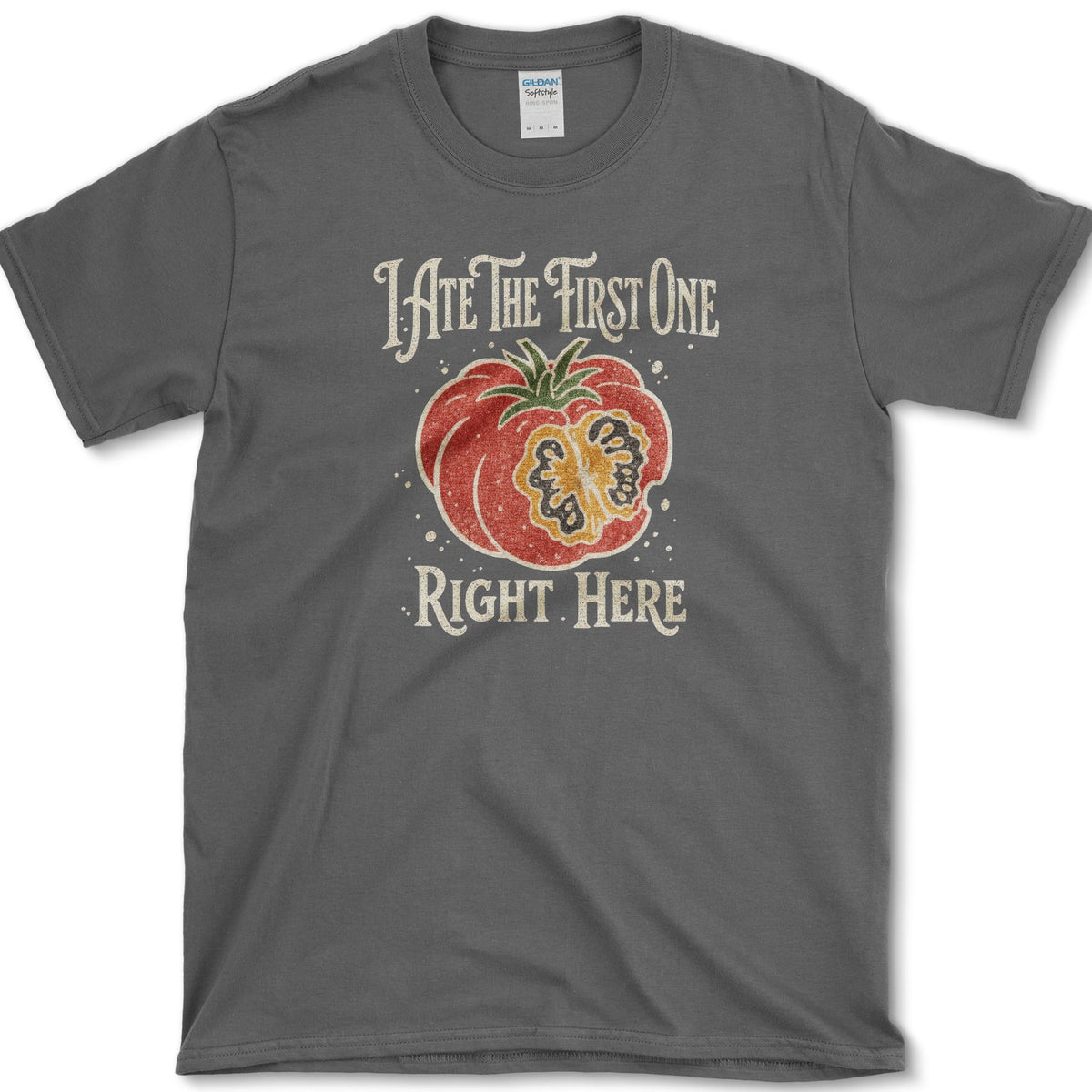 Ripe sliced garden tomato beneath I Ate the First One Right Here lettering on a T-shirt