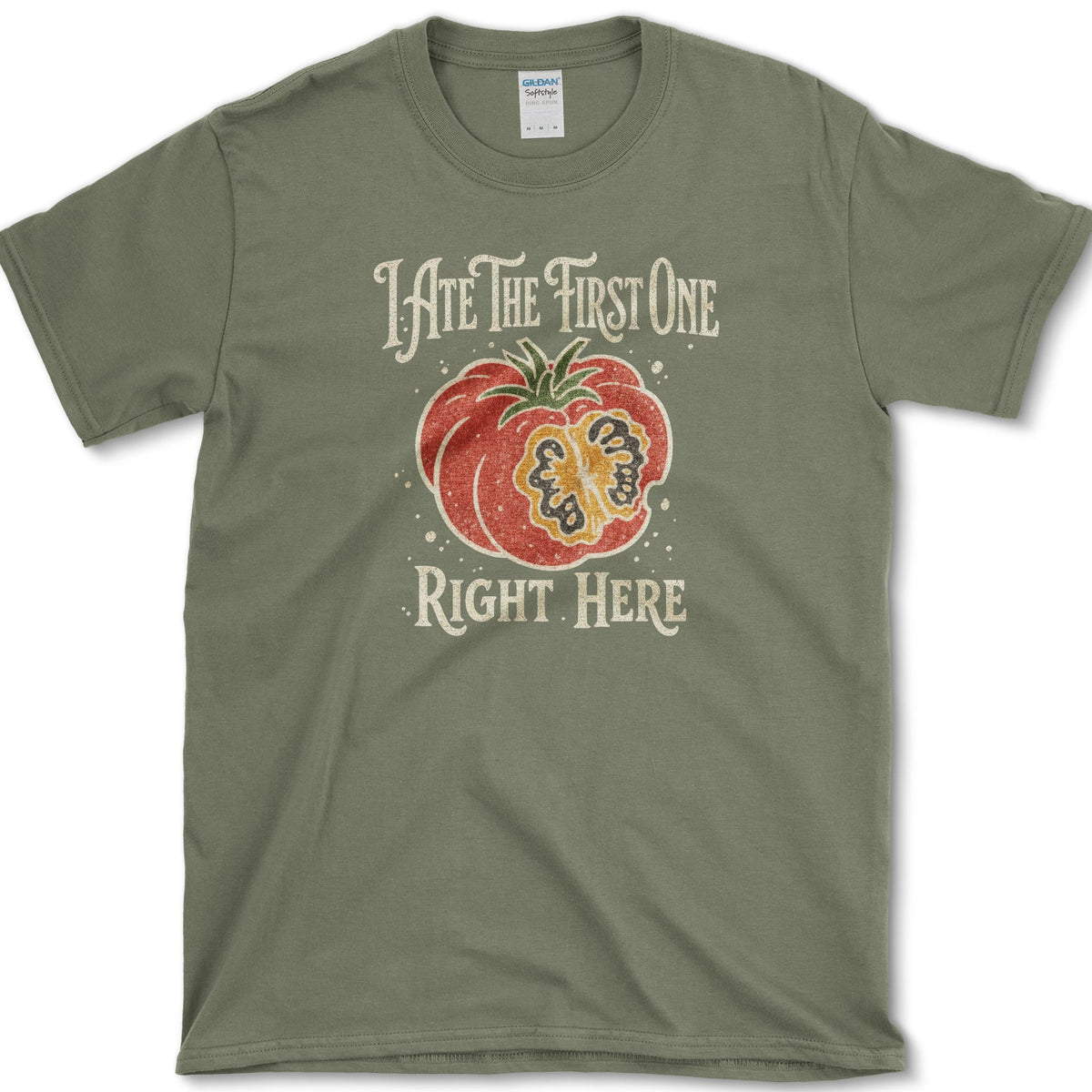 Ripe sliced garden tomato beneath I Ate the First One Right Here lettering on a T-shirt