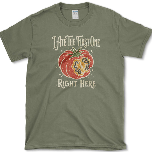 Ripe sliced garden tomato beneath I Ate the First One Right Here lettering on a T-shirt