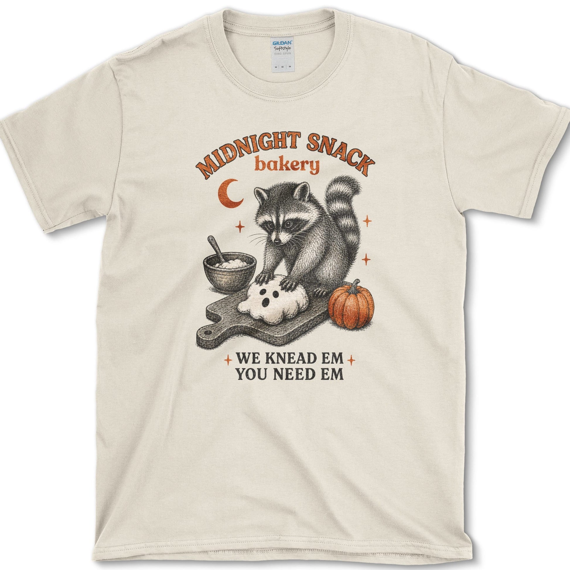 Midnight Snack Bakery artwork featuring baking raccoon and raccoon and pumpkin on a t-shirt