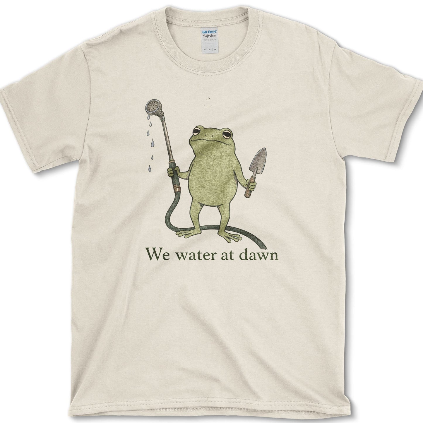 Water At Dawn artwork featuring frog and watering can on a t-shirt